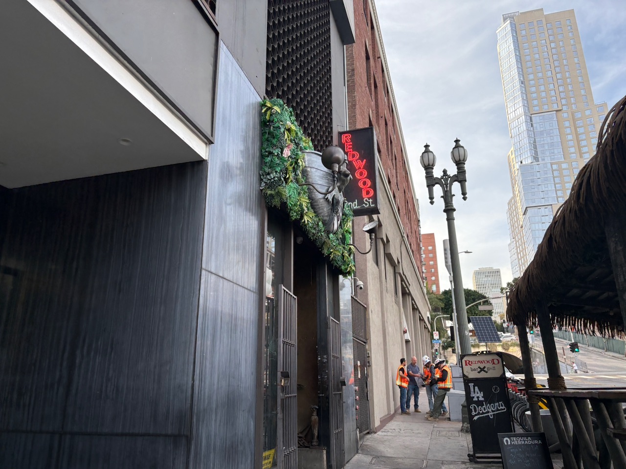 The entrance to Redwood Bar & Grill from the street - a dark facade with greenery and a pirate-themed vibe
